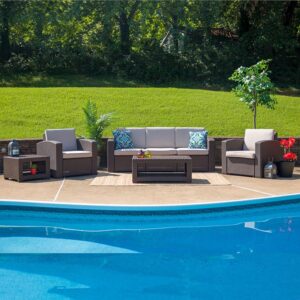 Create a breezy style and bring a new energy to your home with this stylish outdoor seating set. The durable resin frame offers a smart appearance which replicates rattan. Dense foam cushions and deep seating enhance the comfort level. All-weather cushions will hold up all season long and are zipper removable for washing purposes. The table features a lower shelf for storage of your dining and relaxation essentials or add some decorations for a splash of color. This trendy set allows you to relax with friends and family on the patio
