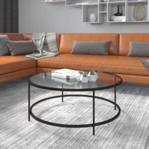 polished look with this round clear glass coffee table with matte black steel legs. This living room coffee table successfully marries the beauty of glass with the strength of steel that makes a definite statement. The round top and frame contrast with the vertical legs to provide a contemporary look that's sure to tie any trendy room's presentation together. Whether you have a spacious modern home or a one bedroom apartment this round coffee table will fit right in. The round design is perfect for an L-shaped sectional in the living room
