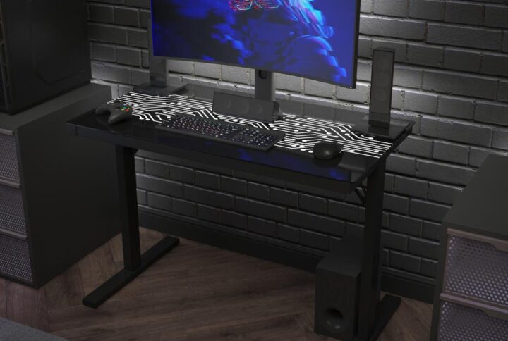 Enhance your gaming or workday experience with the striking looks of this commercial grade computer desk featuring a tempered glass top with color changing LED lights in a circuit board pattern. Change the color to match your decor or mood and go from solid to flashing with the wired LED light remote control. The 8mm tempered glass top is water resistant and the powder coated steel frame with adjustable floor glides gives you a level playing field and holds up to 110 lbs. static weight to accommodate your gear or office equipment. Assembly takes less than 30 minutes and a damp cloth will keep your desk looking great.
