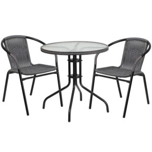 this round table and 2 chair set is just what you need. The table's rippled designer glass top has a smooth surface for keeping items level. The rattan edge band complements the chairs and adds just the right touch for a stylish cohesive look. The lightweight chairs feature a curved back