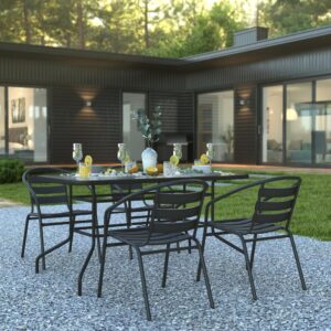 but is smooth to the touch to keep items level. The black metal base and frame provide a striking contrast to the glass top for an on-trend look. The overall design is enhanced by the aluminum slat back chairs