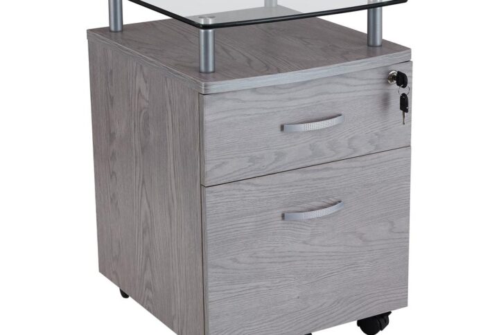 The Techni Mobili Rolling Glass Top File Cabinet features a locking top drawer and a lower hanging file drawer providing secure storage. Locking mechanism locks all drawers of cabinet. 5 casters offers additional support and easy mobility. It is made of MDF with a moisture laminate veneer on scratch-resistant powder-coated steel supports. Shelf is made of a heavy-duty 8 mm tempered safety glass. Cabinet and Glass Top each holds up to 20lbs. Color: Grey