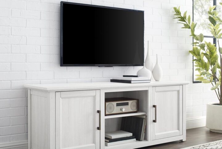 Gather together for a family movie night with the Camden 58” Low Profile TV Stand. This TV stand features two cabinets with an adjustable shelf in each