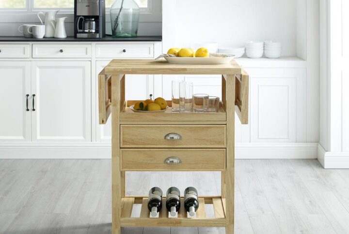 Simple design and high function are the hallmarks of the Bristol Double Drop Leaf Kitchen Cart. The drop leaf design doubles the counter space which can be used for food prep or as additional dining space. Two full-extension drawers and an open shelf provide ample storage