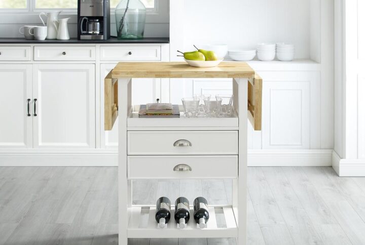 Simple design and high function are the hallmarks of the Bristol Double Drop Leaf Kitchen Cart. The drop leaf design doubles the counter space which can be used for food prep or as additional dining space. Two full-extension drawers and an open shelf provide ample storage