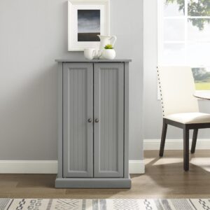 the Seaside Accent Cabinet exudes coastal elegance. This cabinet features double doors with classic beadboard paneling and genuine metal hardware. Simple yet versatile