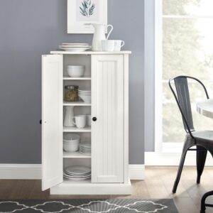 the Seaside Accent Cabinet exudes coastal elegance. This cabinet features double doors with classic beadboard paneling and genuine metal hardware. Simple yet versatile