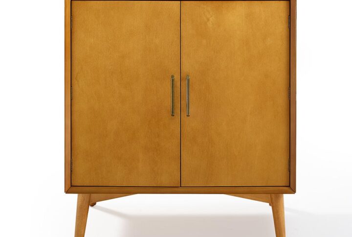 Shake up a drink and showcase mid-century modern style with the Landon Bar Cabinet. Featuring a sleek profile and classic tapered legs