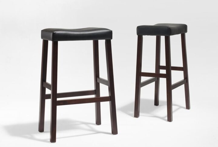 Simplicity and comfort are hallmarks of the Saddle Seat 2pc Bar Stool Set. The curved seat is upholstered in a durable yet stylish faux leather