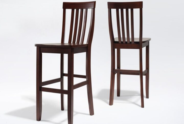The Schoolhouse 2pc Bar Stool Set is crafted for style and long-lasting comfort. With a curved slat back and contoured seat