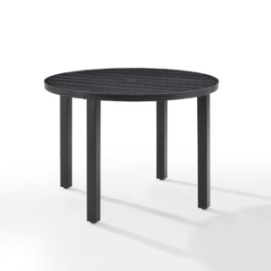 Gather around the Kaplan Round Dining Table for a cozy meal al fresco. The round table features a slatted design that elevates the sturdy steel construction. A standard umbrella hole allows you to add some shade on a hot summer day. Simple and stunning