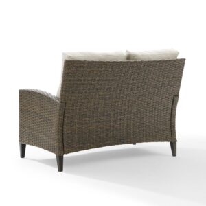 this two-seat outdoor sofa is built from all-weather resin wicker over a powder-coated steel frame. Plush seat and back cushions covered in olefin fabric offer durable comfort