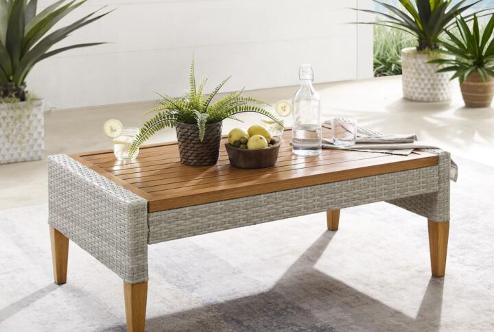 A stylish mix of elements come together to create the Capella Outdoor Coffee Table. Featuring all-weather resin wicker and a slatted steel top hand-painted to look like wood