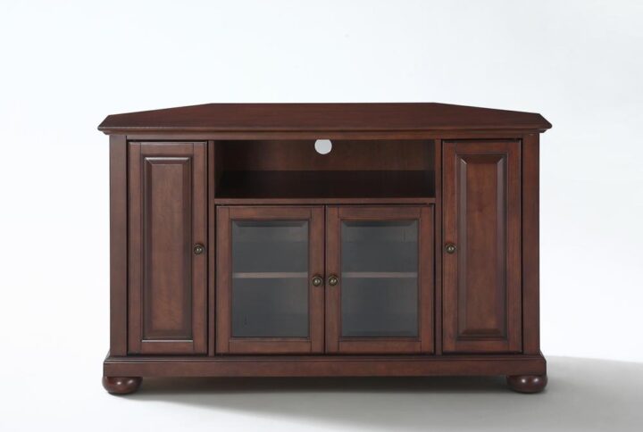 The Alexandria 48” Corner TV Cabinet accommodates most flat-panel TVs up to 50-inches and tucks neatly into any corner of your home. Two cabinets have raised panel doors for concealed storage. The center cabinet has beveled glass doors that protect valued electronic components while allowing for complete use of remote controls. The open storage area generously houses a variety of media players