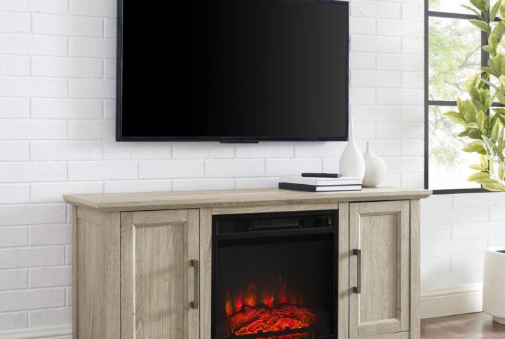 Cozy up for a relaxing evening with the Camden 48” Low Profile TV Stand with fireplace. This tv console looks great showcasing your television while keeping media necessities hidden away. Each cabinet features an adjustable shelf that adapts to your storage needs. With an electric fireplace in the center compartment
