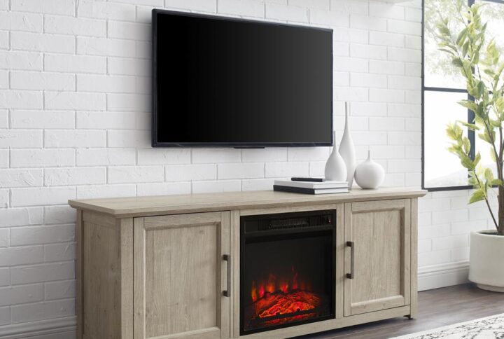 Cozy up for a relaxing evening with the Camden 58” Low Profile TV Stand with fireplace. This tv console looks great showcasing your television while keeping media necessities hidden away. Each cabinet features an adjustable shelf that adapts to your storage needs. With an electric fireplace in the center compartment