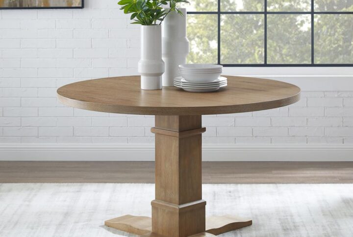 Achieve the look of laid-back elegance with the Joanna Round Dining Table. The substantial pedestal base and natural finish offer a blend of classic style and rustic chic. Both charming and spacious