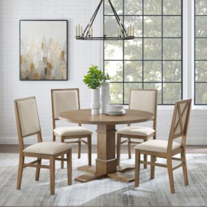 offering seating for up to four diners. Each chair features upholstered backs and seats with a classic wooden X design on the back. Balancing the table’s substantial pedestal base is a spacious tabletop