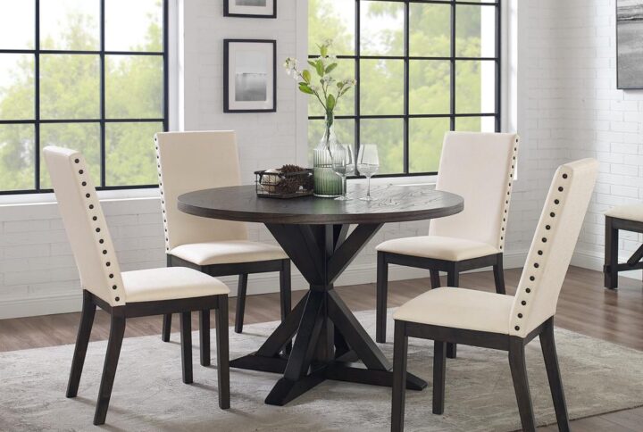The Hayden 5pc Round Dining Set brings modern farmhouse style to family gatherings. The large round table top can comfortably accommodate four diners for a rustic family meal. With intersecting legs