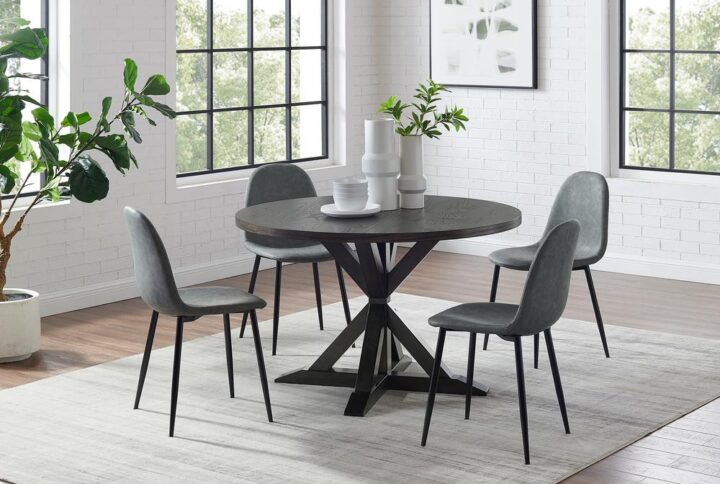 The Hayden 5pc Round Dining Set is sure to be a showstopper with its combination of farmhouse charm and sleek modern seating. Pairing a substantial wood table with upholstered faux leather chairs