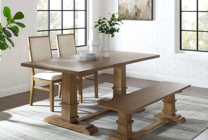 The Joanna 4pc Dining Set embodies the laid-back elegance of modern farmhouse design. Featuring a large rectangle trestle table