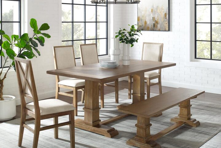 The Joanna 6pc Dining Set embodies the laid-back elegance of modern farmhouse design. Featuring a large rectangle trestle table