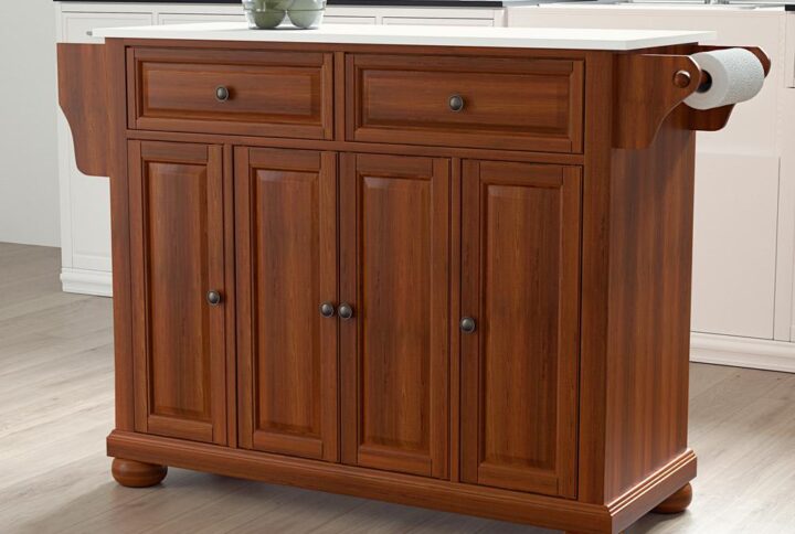 The Alexandria Full-Size Kitchen Island adds enduring style and storage to your kitchen. Featuring three cabinets