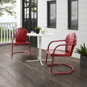 the Tulip 3pc Bistro Set combines vintage style with classic function. Two scalloped chairs in vibrant colors surround a simple metal bistro table for a fun and functional outdoor lounging experience. The retro silhouette of each chair sits atop a cantilever base that provides just enough flex for lounging in comfort. The table’s sturdy pedestal base is comprised of four metal legs and easily tucks between the chairs