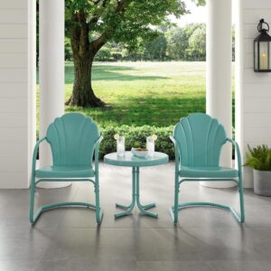 the Tulip 3pc Outdoor Chair Set combines vintage style with classic function. Two scalloped chairs in vibrant colors surround a simple metal side table for a fun and functional outdoor lounging experience. The retro silhouette of each patio chair sits atop a cantilever base that provides just enough flex for lounging in comfort. The outdoor side table has a  sturdy pedestal base comprised of four metal legs and easily tucks between the chairs