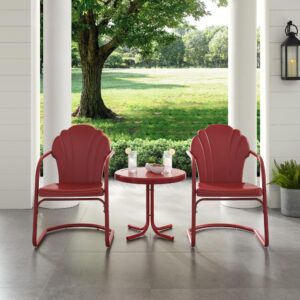 the Tulip 3pc Outdoor Chair Set combines vintage style with classic function. Two scalloped chairs in vibrant colors surround a simple metal side table for a fun and functional outdoor lounging experience. The retro silhouette of each patio chair sits atop a cantilever base that provides just enough flex for lounging in comfort. The outdoor side table has a  sturdy pedestal base comprised of four metal legs and easily tucks between the chairs