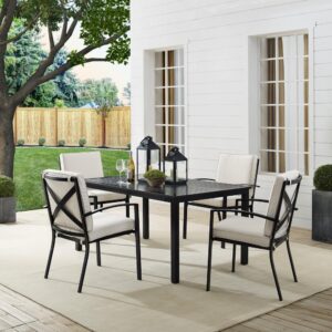Gather around the Kaplan 5pc Outdoor Dining Set for an elegant meal al fresco. The rectangle table features a slatted design that elevates the sturdy steel construction and creates a perfect partner to the four outdoor dining chairs. Each chair showcases comfy back and seat cushions plus a classic x-back design. The table has a standard umbrella hole that will allow you to add some shade on a hot summer day. Simple and stunning
