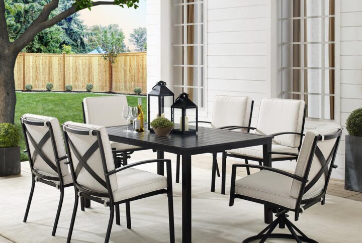 Gather for an elegant outdoor meal with the Kaplan 7pc Outdoor Dining Set. Featuring two 360-degree swivel chairs and four stationary dining chairs that surround a classic rectangle dining table