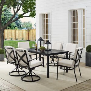Gather for an elegant outdoor meal with the Kaplan 7pc Outdoor Dining Set. Featuring four 360-degree swivel chairs and two stationary dining chairs that surround a classic rectangle dining table