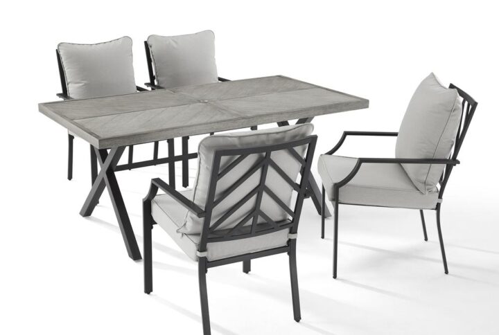 Enjoy a pleasant outdoor meal with the Otto 5pc Outdoor Dining Set. Cushioned stationary patio chairs surround the beautiful faux wood grain metal outdoor table