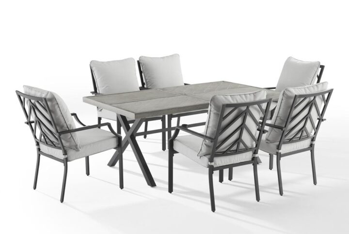 Enjoy a pleasant outdoor meal with the Otto 7pc Outdoor Dining Set. Cushioned stationary patio chairs surround the beautiful faux wood grain metal outdoor table