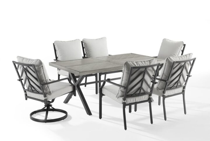 Enjoy a pleasant outdoor meal with the Otto 7pc Outdoor Dining Set. Cushioned stationary and swivel patio chairs surround the beautiful faux wood grain metal outdoor table