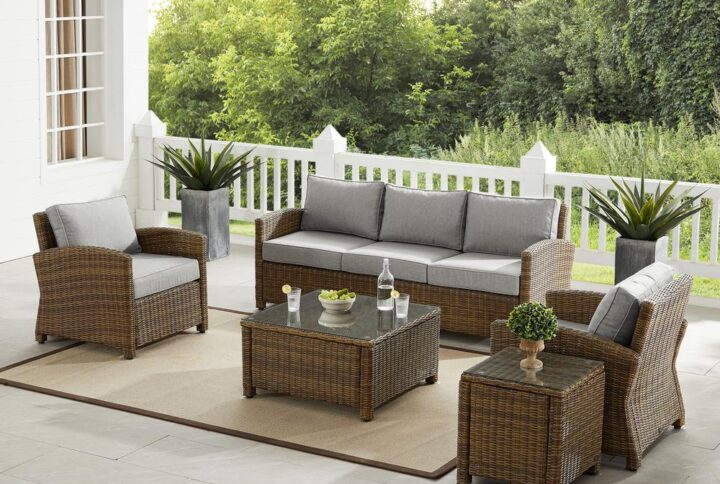 Gather with friends for an evening under the stars with the Bradenton 5pc Sofa Set.  Each piece of the set features sturdy steel frames wrapped in beautiful all-weather wicker. The sofa and armchairs are stylish and comfortable with gently arched arms and thick moisture-resistant cushions. A glass top coffee table and side table tie the whole seating arrangement together