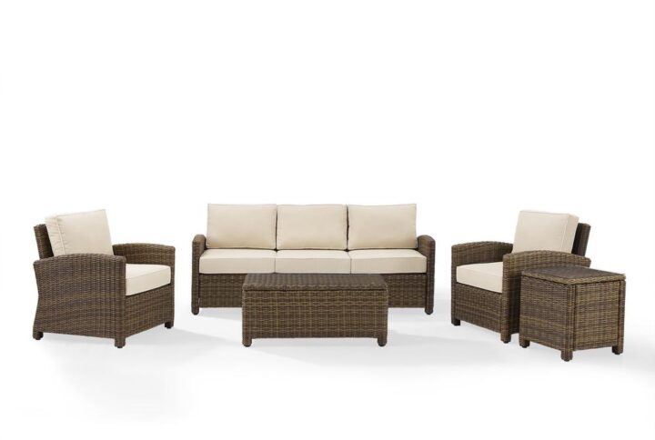 Gather with friends for an evening under the stars with the Bradenton 5pc Sofa Set.  Each piece of the set features sturdy steel frames wrapped in beautiful all-weather wicker. The sofa and armchairs are stylish and comfortable with gently arched arms and thick moisture-resistant cushions. A glass top coffee table and side table tie the whole seating arrangement together