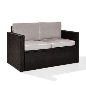 Lounge in comfort on the Palm Harbor Loveseat. Crafted with all-weather resin wicker woven over a durable steel frame