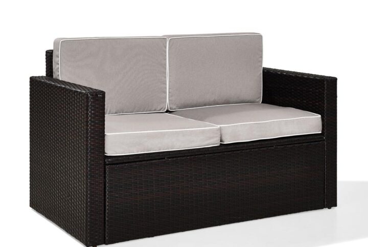 Lounge in comfort on the Palm Harbor Loveseat. Crafted with all-weather resin wicker woven over a durable steel frame
