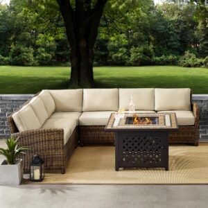 Cozy up in the luxury of the Bradenton 5pc Sectional Set. Sectional seating for up to six hugs the powder-coated steel fire table offering deep seat cushions on all-weather resin wicker. The sectional cushions are covered in a solution-dyed polyester for durability and comfort. The fire table's tiled stone top and lattice paneled base offer a unique design that elevates any outdoor space. The gas controls and a rack for a propane tank are located inside the table's base
