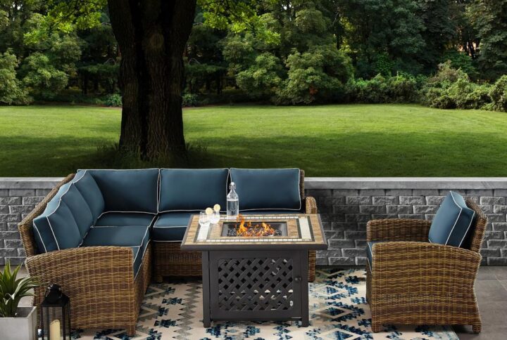 Relax in the luxury of the Bradenton 5pc Sectional Set. Seating for up to six surrounds the powder-coated steel fire table offering deep seat cushions on all-weather resin wicker. The sectional and armchair cushions are covered in solution-dyed polyester for durability and comfort. The fire table's tiled stone top and lattice paneled base offer a unique design that elevates any outdoor space. The gas controls and a rack for a propane tank are located inside the table's base