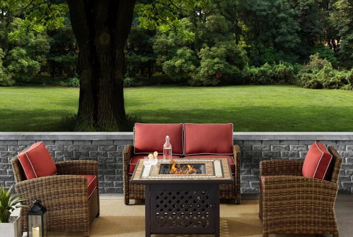 Spend warm summer days and cool summer nights with the Bradenton 4pc Conversation Set. The loveseat and armchairs are made from all-weather resin wicker with seat cushions covered in solution-dyed polyester. The outdoor seating surrounds a fire table constructed from sturdy powder-coated steel. The fire table's tiled top and lattice paneled base offer a unique design that will elevate your outdoor space. The gas controls and a rack for a propane tank are located inside the table's base