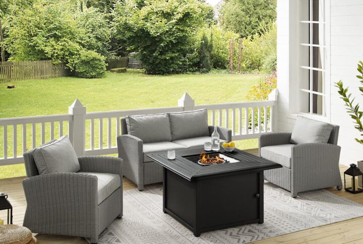 Spend warm summer days and cool summer nights with the Bradenton 4Pc Wicker Conversation Set. The loveseat and arm chairs are made from all-weather resin wicker with cushions covered in solution-dyed polyester. The outdoor seating surrounds a fire table constructed from sturdy powder-coated steel. The fire table's slatted top and solid paneled base offer a simple design that blends with a variety of outdoor spaces. The gas controls and a rack for a propane tank are located inside the table's base