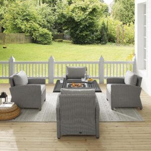 for cozy outdoor entertaining. Each chair features back and seat cushions covered in a solution-dyed polyester providing durability and comfort. The fire table's slatted top and solid paneled base offer a simple design that blends with a variety of outdoor spaces. The gas controls and a rack for a propane tank are located inside the table's base