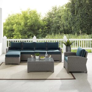 while moisture-resistant cushions top the seating and ottoman. Modular in design