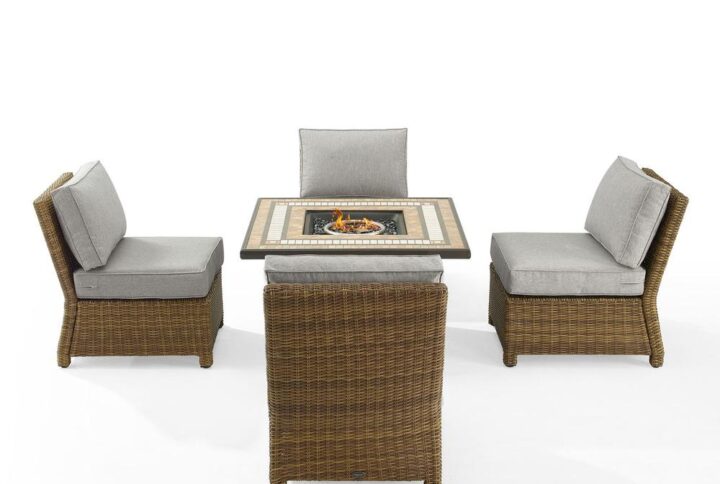 Gather around the fire for a relaxing evening with the Bradenton 5pc Conversation Set. Four all-weather resin wicker armless chairs surround a powder-coated steel fire table