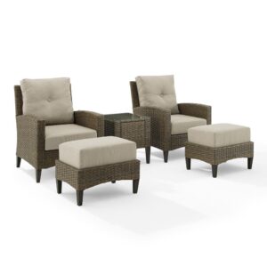 this patio set is built from all-weather resin wicker handwoven over powder-coated steel frames. The cushions for the chairs and ottomans are covered in moisture-resistant olefin fabric. Topped with tempered glass