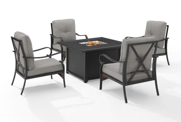 The Dahlia 5pc Conversation Set charms with traditional elements like curved arms and x-back seating. Constructed of powder-coated steel the armchairs offer deep cushioned seats surrounding a propane-powered fire table with a slatted top and solid paneled base. With gas controls and a rack for a propane tank located inside the table's base