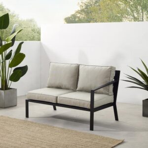 the Clark Sectional Loveseat is an ideal spot to enjoy a cup of coffee in the morning sun. Made from powder-coated steel